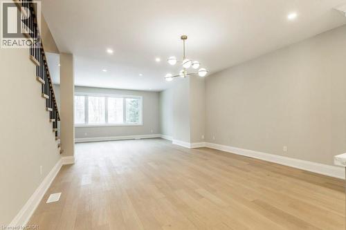 Unfurnished room with a chandelier and light wood-style flooring - 1105 Main Street E, Cambridge, ON - Indoor Photo Showing Other Room