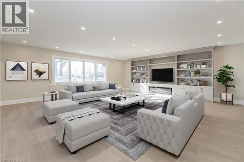 Living room featuring light wood finished floors, recessed lighting, and built in features - 1105 Main Street E, Cambridge, ON - Indoor Photo Showing Living Room