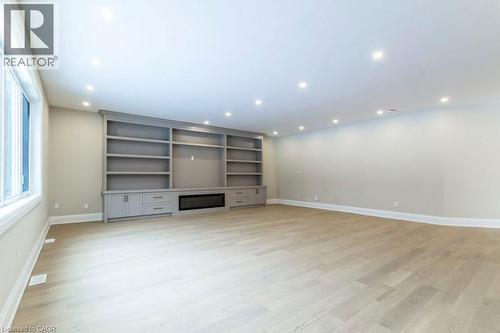 Unfurnished living room featuring light wood-style flooring, recessed lighting, and a glass covered fireplace - 1105 Main Street E, Cambridge, ON - Indoor Photo Showing Other Room