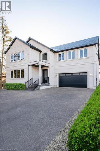 Modern farmhouse with an attached garage and driveway - 1105 Main Street E, Cambridge, ON - Outdoor