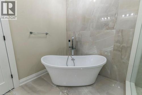 Bathroom featuring a freestanding bath and baseboards - 1105 Main Street E, Cambridge, ON - Indoor Photo Showing Bathroom