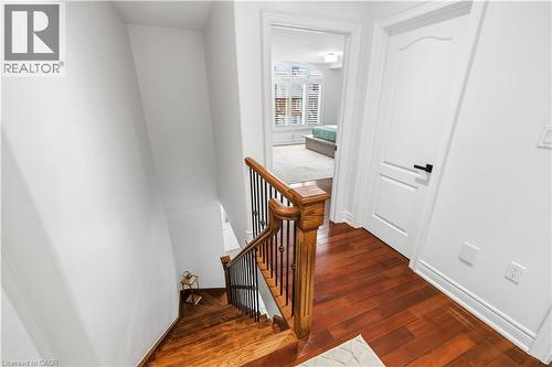 Hardwood flooring and a staircase with wood newel post and balusters - 199 Hunter Street W, Hamilton, ON - Indoor Photo Showing Other Room