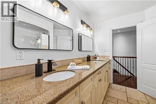 Dual vanity with stone countertop, undermount sinks, and matte black fixtures - 199 Hunter Street W, Hamilton, ON - Indoor Photo Showing Bathroom
