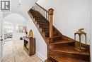 Rich wood staircase with black iron balusters, featuring a substantial newel post - 199 Hunter Street W, Hamilton, ON  - Indoor Photo Showing Other Room 
