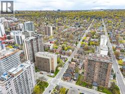 Aerial perspective showcasing a dense urban environment with a mix of residential buildings and extensive tree coverage - 
