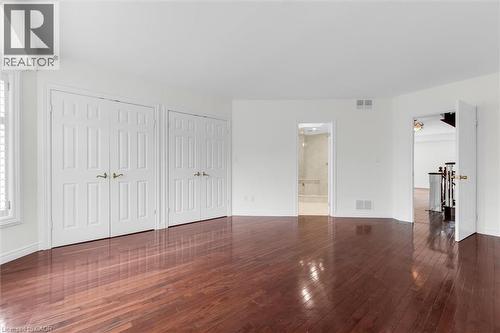 Spacious interior room featuring rich wood-finish flooring, white walls, and bright white trim - 1389 Lakeshore Road, Burlington, ON - Indoor Photo Showing Other Room