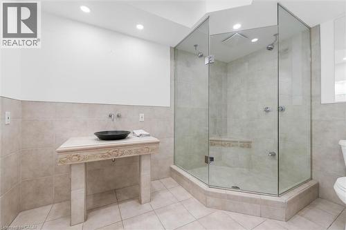 Glass-enclosed shower with a built-in bench, dual shower heads, and recessed lighting - 1389 Lakeshore Road, Burlington, ON - Indoor Photo Showing Bathroom