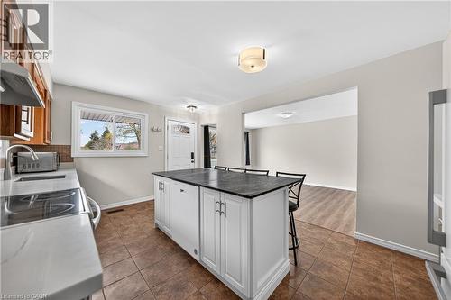 Kitchen with a central island featuring white cabinetry and a dark countertop - 34 Avenue Road, Cambridge, ON - Indoor Photo Showing Kitchen With Double Sink