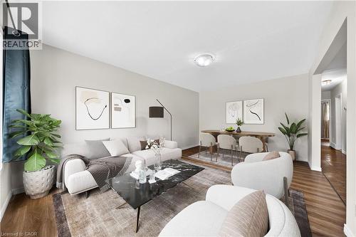Open-concept living and dining area featuring wood-finish flooring, light-toned walls, and recessed lighting - 34 Avenue Road, Cambridge, ON - Indoor Photo Showing Living Room