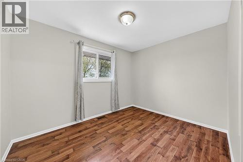 Interior room featuring wood-finish flooring, light gray wall paint, and white baseboards - 34 Avenue Road, Cambridge, ON - Indoor Photo Showing Other Room