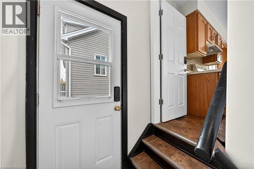 Entryway with a white paneled door featuring an integrated window, a digital lock, and a brass-finish doorknob - 34 Avenue Road, Cambridge, ON - Indoor Photo Showing Other Room