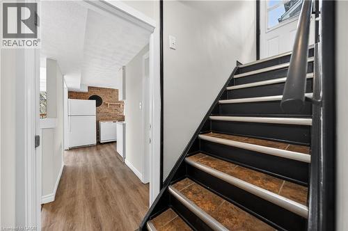 Staircase with dark risers, light treads, and a dark handrail - 34 Avenue Road, Cambridge, ON - Indoor Photo Showing Other Room