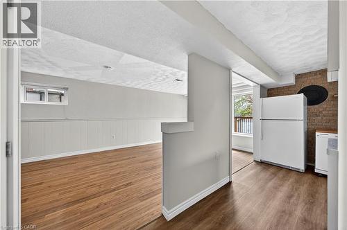 Expansive finished area featuring wood-finish flooring and wainscoting - 34 Avenue Road, Cambridge, ON - Indoor
