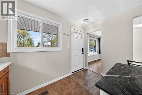 Entryway featuring tile flooring, a white paneled door with leaded glass insert, and a contemporary flush-mount ceiling light - 34 Avenue Road, Cambridge, ON - Indoor