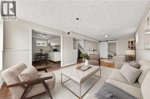 Open-concept living space featuring wood-finish flooring, wainscoting, and recessed lighting - 34 Avenue Road, Cambridge, ON - Indoor Photo Showing Living Room