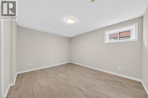 Spacious room featuring light wood-finish flooring, neutral wall paint, and white trim - 34 Avenue Road, Cambridge, ON - Indoor Photo Showing Other Room