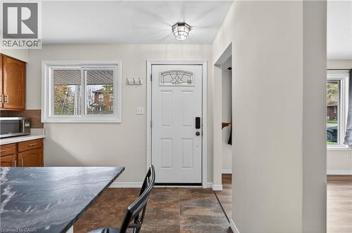 Entryway featuring a white paneled door with decorative glass inserts, a flush-mount ceiling light, and durable tile flooring - 34 Avenue Road, Cambridge, ON - Indoor