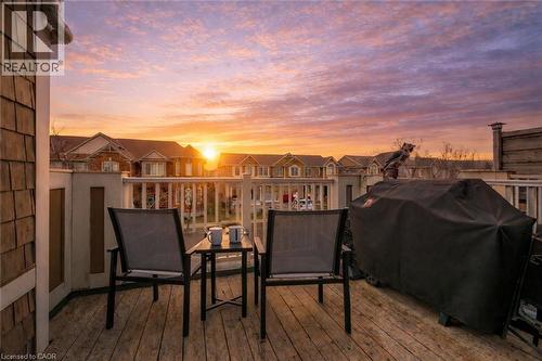 Exterior deck with wood-finish flooring and white railings - 525 Cavanagh Lane, Milton, ON - Outdoor