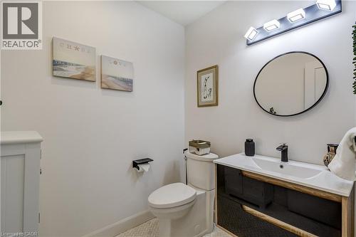 Bathroom featuring a vanity with an integrated sink, black cabinetry, and wood-finish accents - 29 Wiltshire Place, Ancaster, ON - Indoor Photo Showing Bathroom