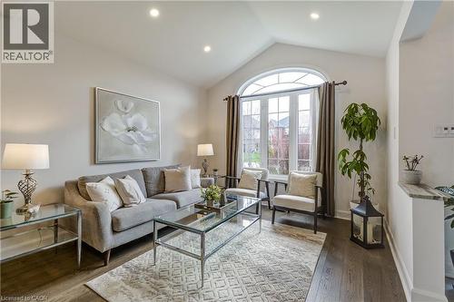 Vaulted ceiling with recessed lighting, complemented by dark wood-finish flooring - 29 Wiltshire Place, Ancaster, ON - Indoor Photo Showing Living Room