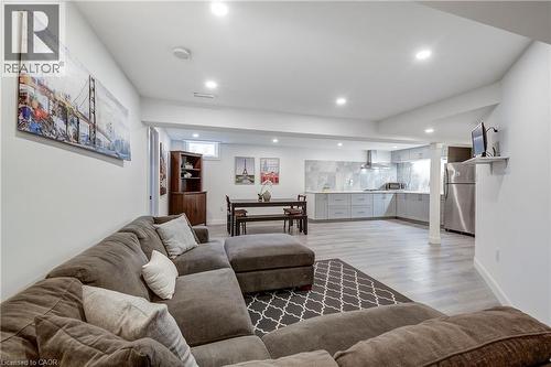 Open-concept living space with recessed lighting and light wood-finish flooring - 29 Wiltshire Place, Ancaster, ON - Indoor Photo Showing Living Room