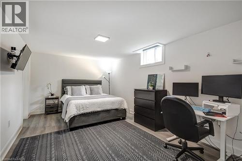 Room featuring wood-finish flooring, a neutral color palette, recessed ceiling lighting, and a window providing natural illumination - 29 Wiltshire Place, Ancaster, ON - Indoor