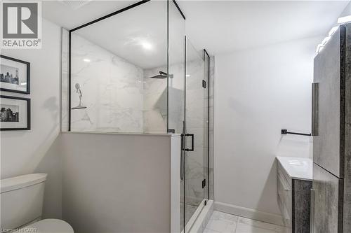 Shower enclosure featuring clear glass panels with matte black trim, a rainfall showerhead, and a handheld spray - 29 Wiltshire Place, Ancaster, ON - Indoor Photo Showing Bathroom