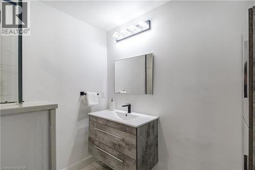 Floating vanity with wood-look finish and integrated white sink - 29 Wiltshire Place, Ancaster, ON - Indoor Photo Showing Bathroom