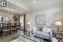 Open-concept living and dining areas featuring wood-finish flooring, recessed lighting, and a vaulted ceiling - 29 Wiltshire Place, Ancaster, ON  - Indoor 