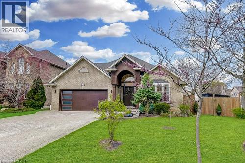 Brick facade residence featuring an arched portico entry and a gabled roofline - 29 Wiltshire Place, Ancaster, ON - Outdoor With Facade