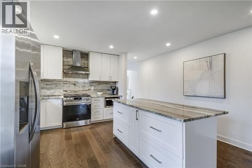 Modern kitchen featuring white cabinetry and dark wood-finish flooring - 29 Wiltshire Place, Ancaster, ON - Indoor Photo Showing Kitchen With Upgraded Kitchen