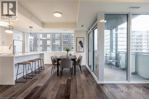 Dining area featuring a tray ceiling and dark wood finished floors - 500 Brock Avenue Unit# 808, Burlington, ON - Indoor