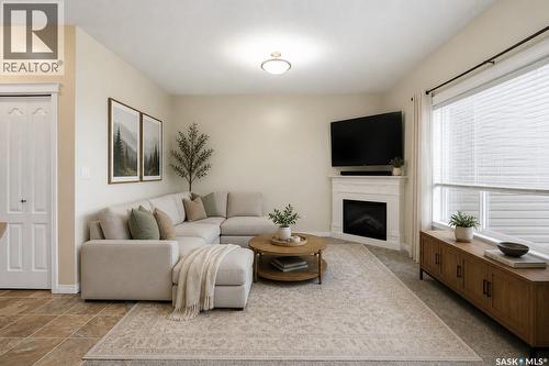 210 3818 Dewdney Avenue E, Regina, SK - Indoor Photo Showing Living Room With Fireplace