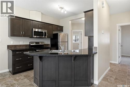 210 3818 Dewdney Avenue E, Regina, SK - Indoor Photo Showing Kitchen With Double Sink
