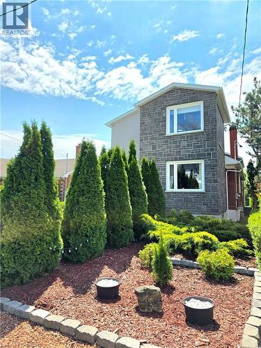 Very low outdoor maintenance with no grass to cut. Christmas lights included in cedars. - 16 Forest Hill Road, St. Catharines, ON - Outdoor
