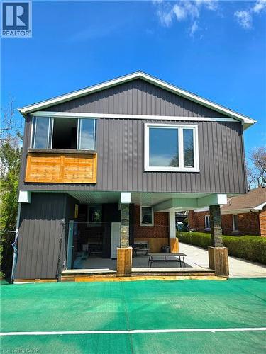 Contemporary exterior featuring vertical panel siding, a covered patio, balcony and court netting - 16 Forest Hill Road, St. Catharines, ON - Outdoor