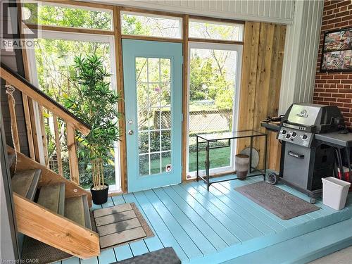Enclosed patio featuring a wood floor, large windows, BBQ area and stairs to the studio - 16 Forest Hill Road, St. Catharines, ON -  Photo Showing Other Room