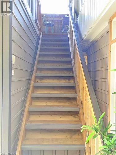 Exterior wood staircase with light-toned wood treads and grey risers, featuring a natural wood railing - 16 Forest Hill Road, St. Catharines, ON - Indoor Photo Showing Other Room