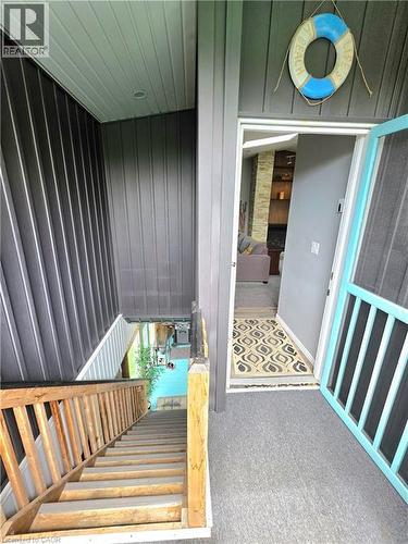 Front entry with gray carpet flooring and a light blue screen door - 16 Forest Hill Road, St. Catharines, ON -  With Exterior