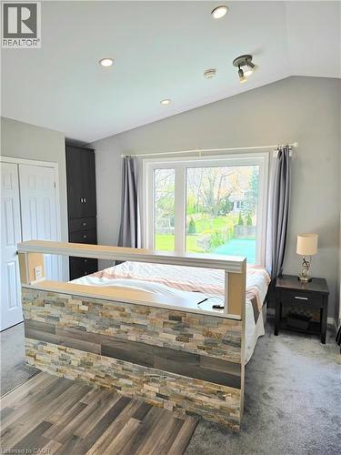 Vaulted ceiling with recessed lighting and a beautiful view of the tennis court, facing south for all day sun - 16 Forest Hill Road, St. Catharines, ON - Indoor Photo Showing Bedroom