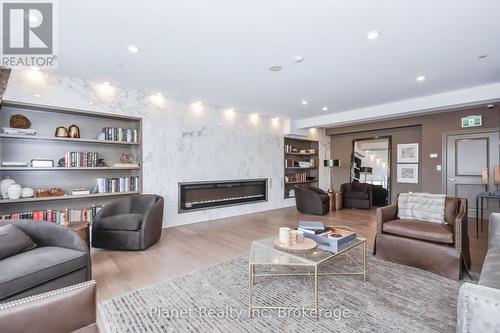 501 - 150 Wellington Street E, Guelph (Downtown), ON - Indoor Photo Showing Living Room With Fireplace