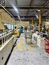 Industrial warehouse space featuring concrete flooring, high ceilings with exposed metal beams, and fluorescent lighting - 550 Parkside Drive Unit# A13-16, Waterloo, ON 
