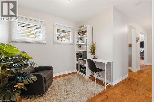 Flexible room featuring two windows with horizontal blinds, light-toned walls, and a plush area rug - 120 Elgin Crescent, Waterloo, ON - Indoor