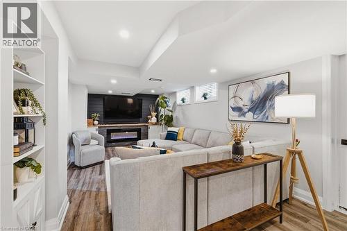 Recessed lighting illuminates wood-finish flooring - 120 Elgin Crescent, Waterloo, ON - Indoor Photo Showing Living Room With Fireplace