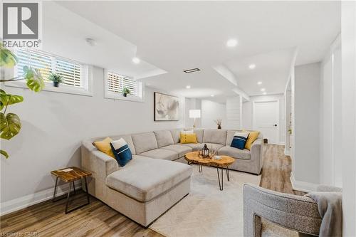 Spacious room featuring wood-finish flooring, recessed lighting, and bright white walls - 120 Elgin Crescent, Waterloo, ON - Indoor Photo Showing Living Room