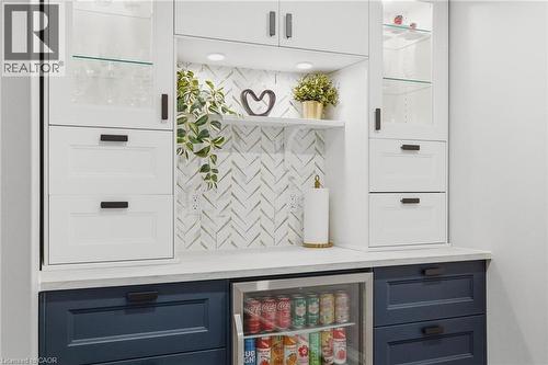 Built-in beverage station featuring white and navy cabinetry, a white countertop, and a herringbone-patterned tile backsplash - 120 Elgin Crescent, Waterloo, ON - Indoor Photo Showing Other Room