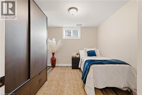 Room featuring wood-finish flooring, a neutral color palette, and a window with white blinds - 120 Elgin Crescent, Waterloo, ON - Indoor Photo Showing Bedroom