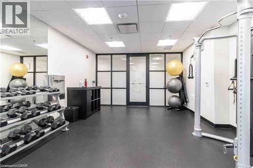 Fitness room featuring resilient black flooring and expansive mirrored wall - 251 Northfield Drive E Unit# 406, Waterloo, ON - Indoor Photo Showing Gym Room