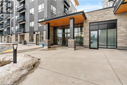 Modern multi-story building featuring stone veneer and dark paneling - 251 Northfield Drive E Unit# 406, Waterloo, ON - Outdoor