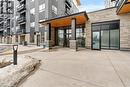 Modern multi-story building featuring stone veneer and dark paneling - 251 Northfield Drive E Unit# 406, Waterloo, ON  - Outdoor 